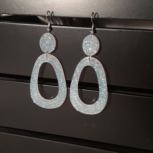 White shiny, sparkly earrings.